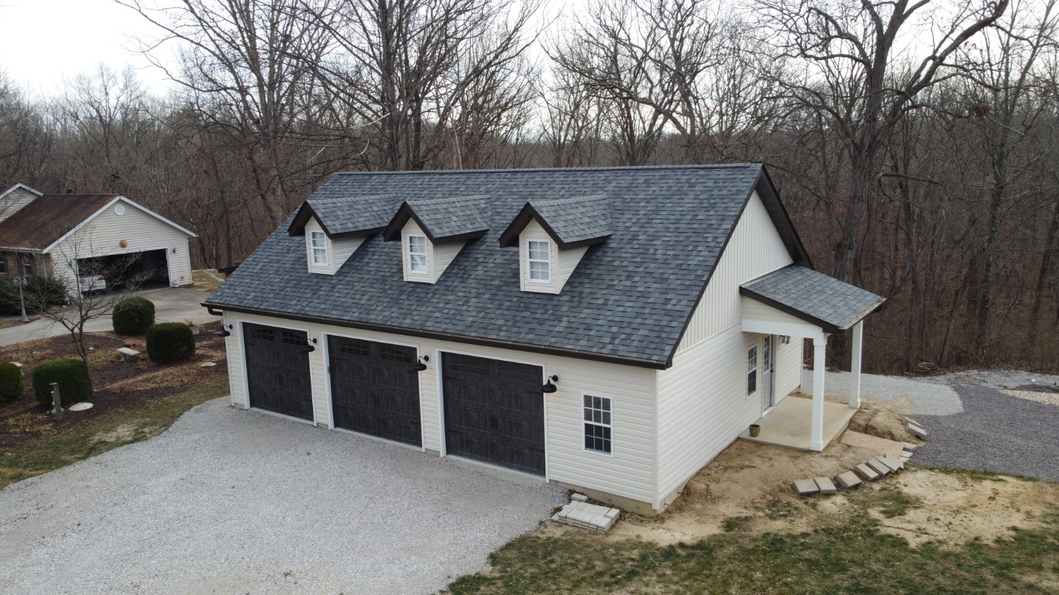 Completed custom three-car garage viewed from an elevated angle